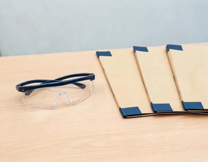 Shooting glasses prescription brief beside factory quote folders